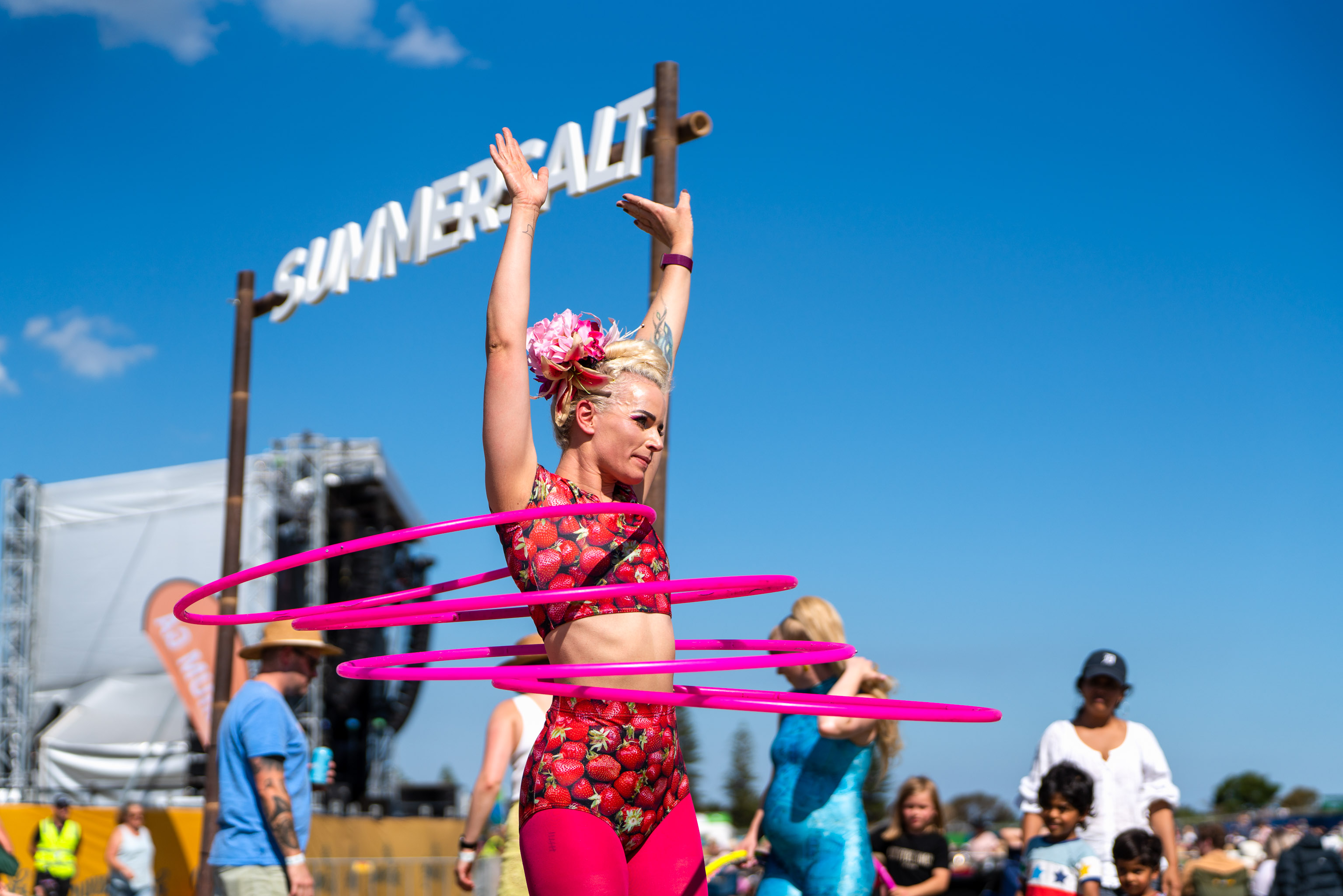Summersalt - woman with 4 hula hoops infront of Summersalt sign